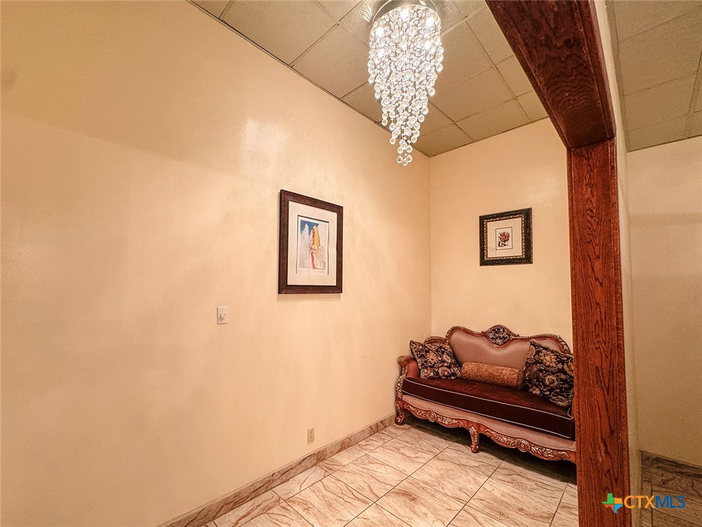 202 East Forrest Street Victoria, TX 77901 - Photo 28 of 47 a bedroom with furniture and a chandelier