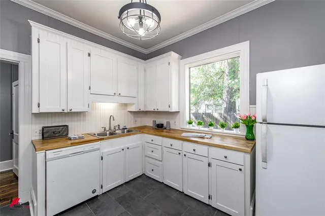 a kitchen with granite countertop white cabinets and white appliances