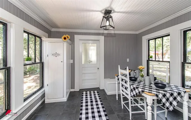 a dining room with furniture a chandelier and wooden floor