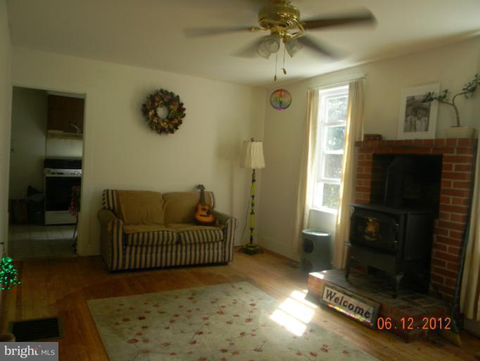 3525 Young Road Manchester, MD 21102 - Photo 7 of 26 a living room with a couch and a dining table