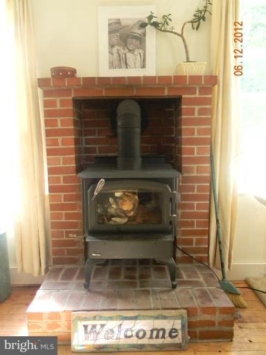 3525 Young Road Manchester, MD 21102 - Photo 8 of 26 a fireplace with a clock on wall