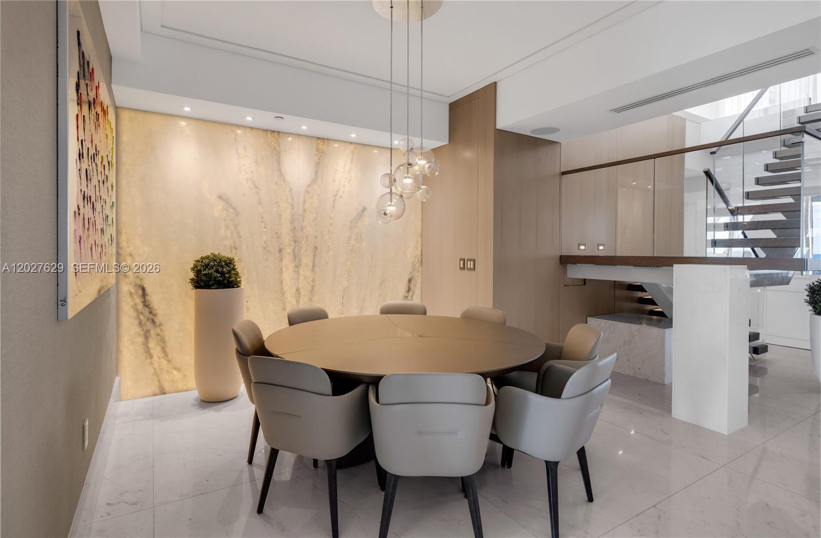 799 Crandon Boulevard, Unit PH8 Key Biscayne, FL 33149 - Photo 6 of 47 a view of a dining room with furniture and wooden floor
