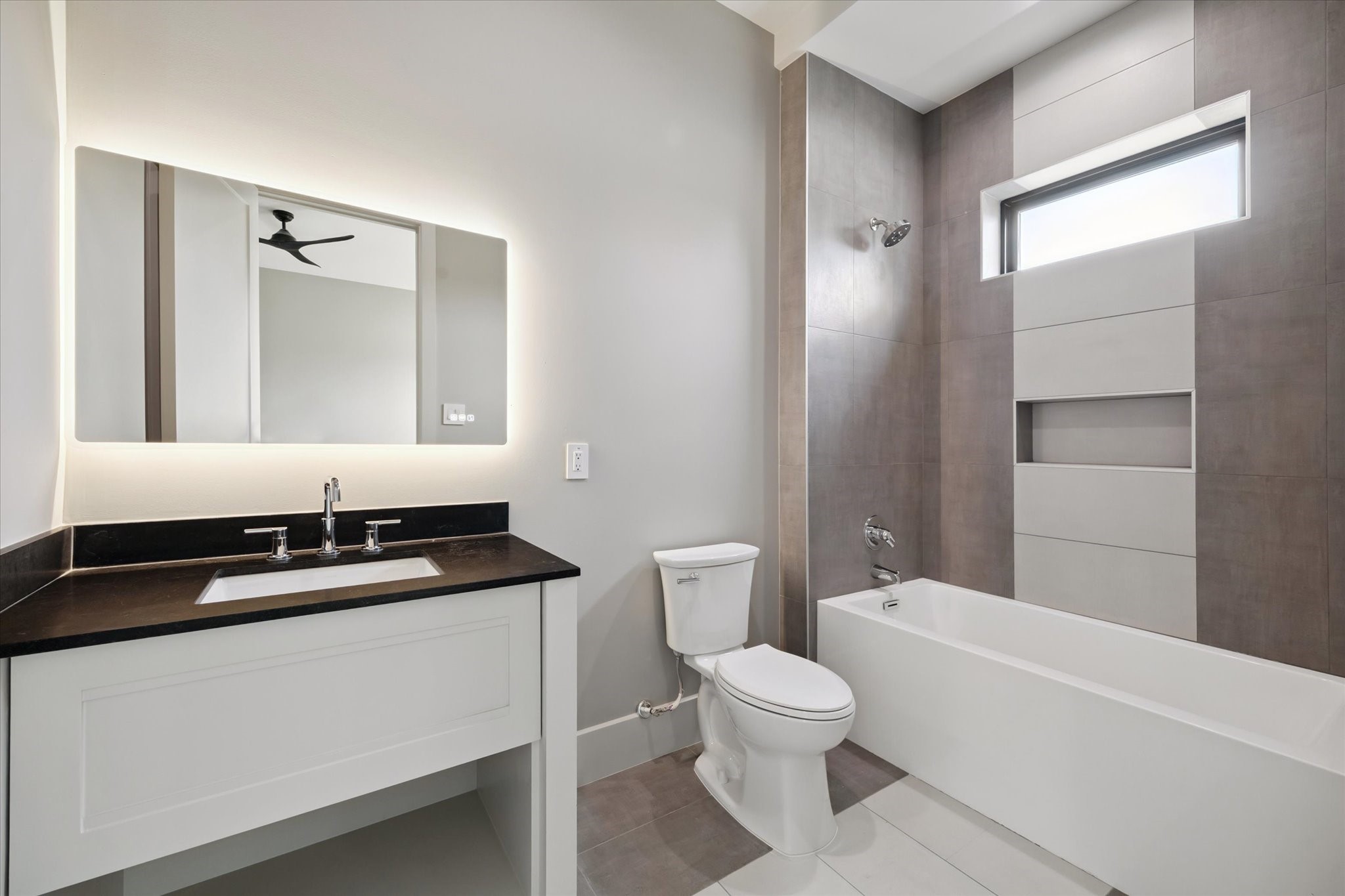 2120 Branard Street Houston, TX 77098 - Photo 25 of 33 a bathroom with a granite countertop sink a toilet and shower