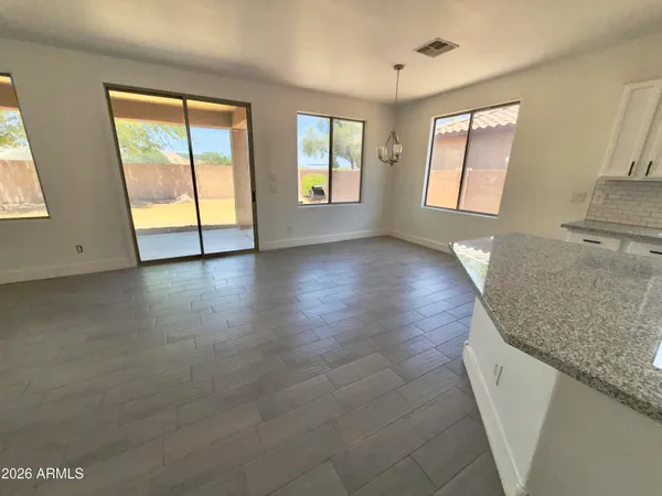 a open kitchen with wooden floors and white walls