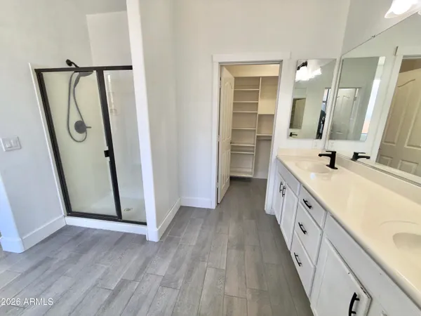 a view of a hallway with wooden floor and windows