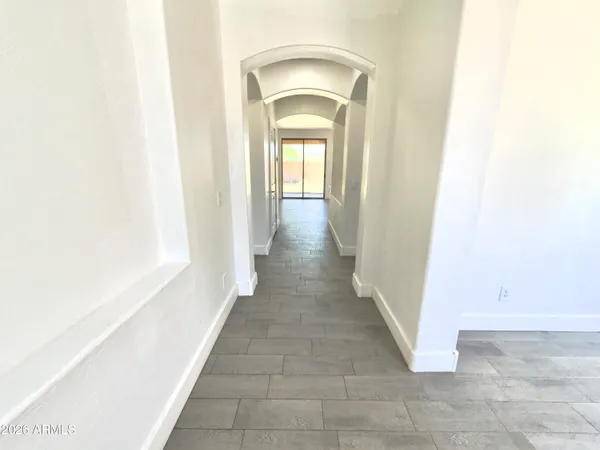 a view of a room with wooden floor and window