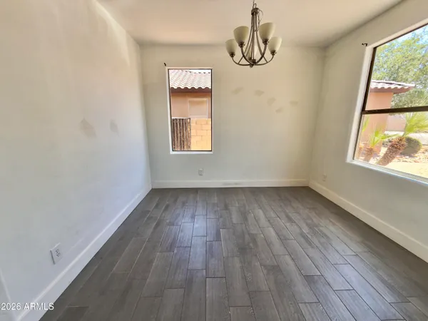 a view of a room with wooden floor and white walls