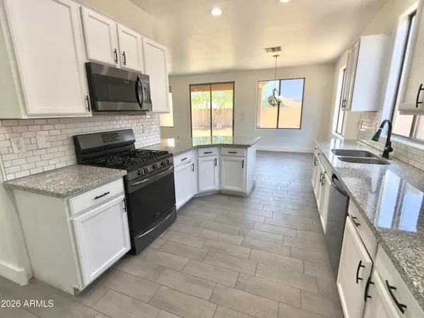 a large kitchen with stainless steel appliances granite countertop plenty of counter space