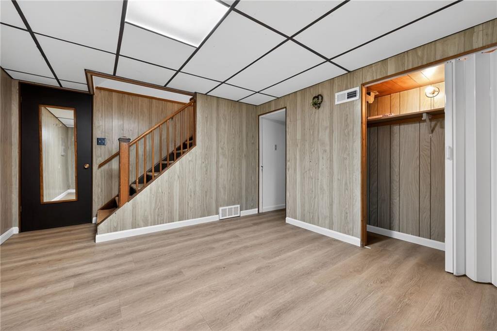 213 Tilford Road Pittsburgh, PA 15235 - Photo 14 of 20 a view of a hallway with wooden floor and stairs