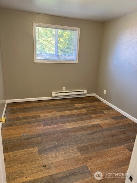 2716 South 258th Place Kent, WA 98032 - Photo 9 of 11 a view of a room with wooden floor and a window