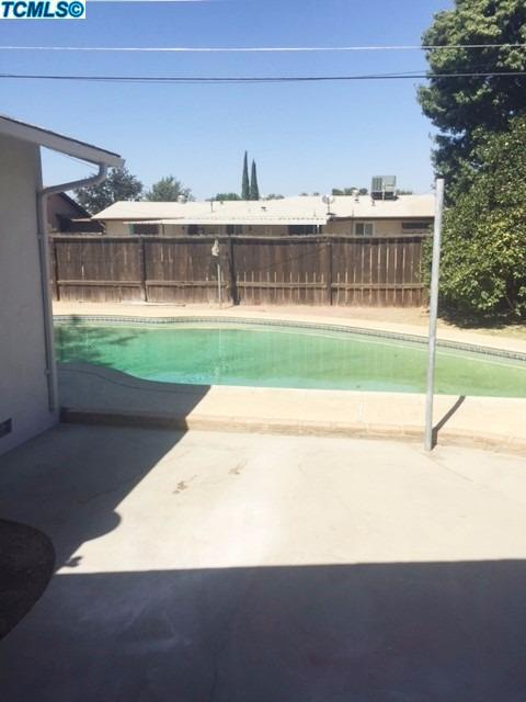 122 West Spring Lane Lemoore, CA 93245 - Photo 16 of 17 a view of a house with a yard and furniture