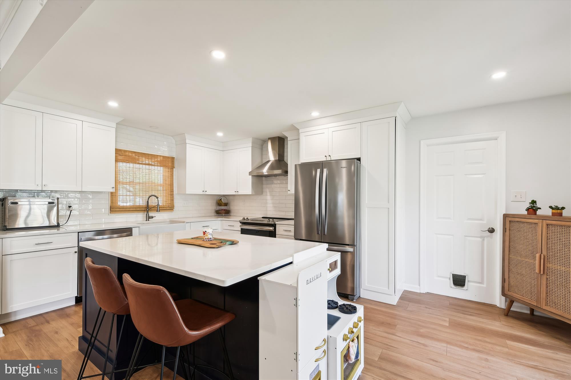 421 Haverhill Road Joppa, MD 21085 - Photo 13 of 32 a kitchen with a dining table chairs refrigerator and cabinets