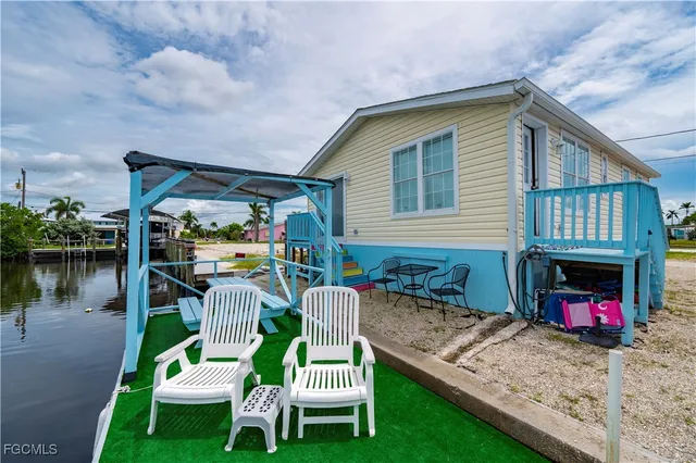 a front view of house with yard and outdoor seating