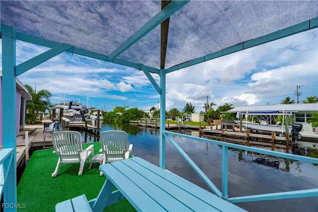 a view of a swimming pool with outdoor seating