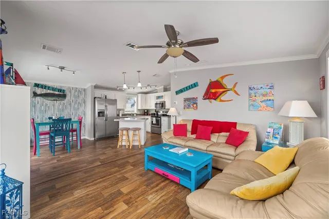 a living room with furniture and kitchen view