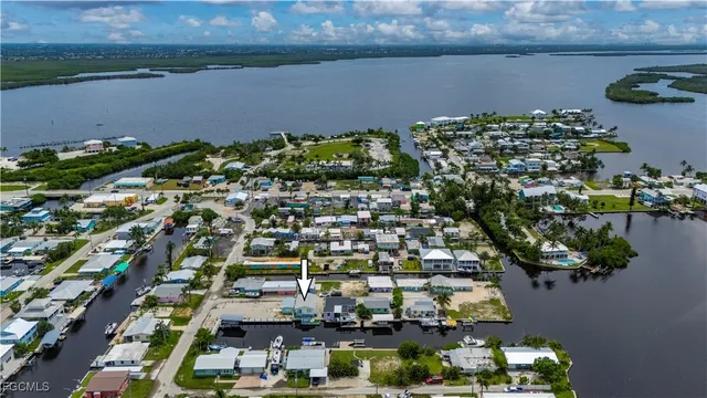 an aerial view of a residential houses with outdoor space and lake view