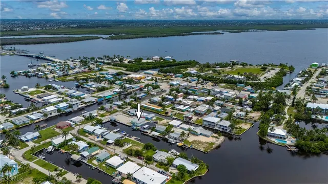 an aerial view of a residential houses with outdoor space and lake view