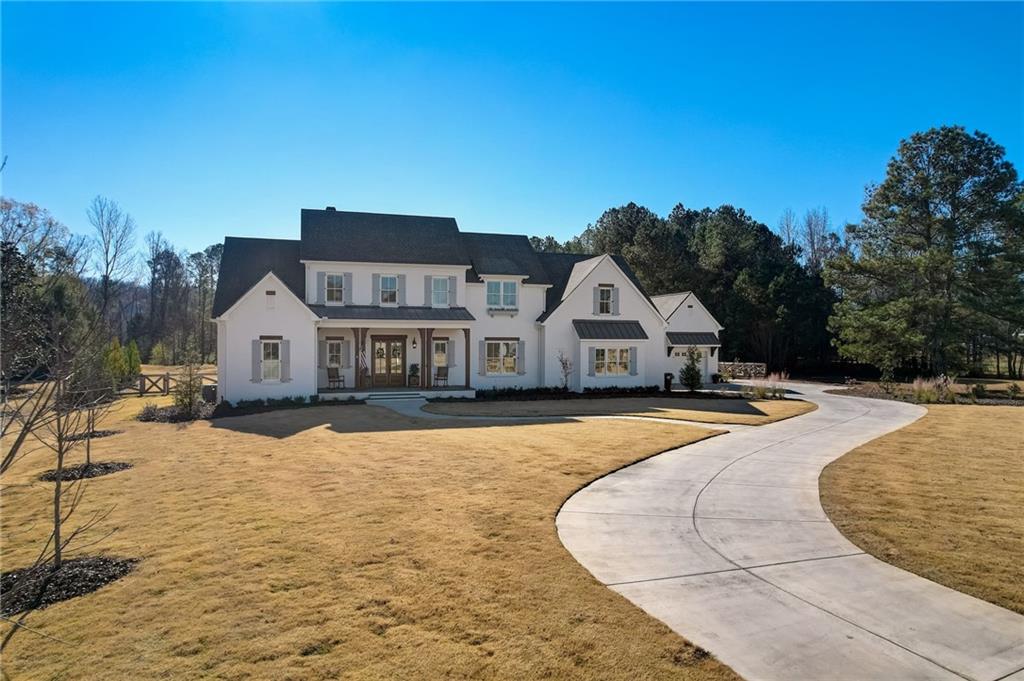 a view of house with yard and covered with snow in front of house
