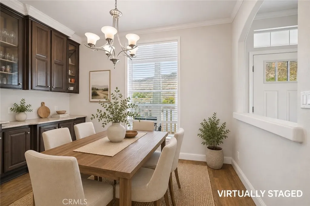 250 East Telegraph Road, Unit 307 Fillmore, CA 93015 - Photo 9 of 36 a view of a dining room with furniture and chandelier