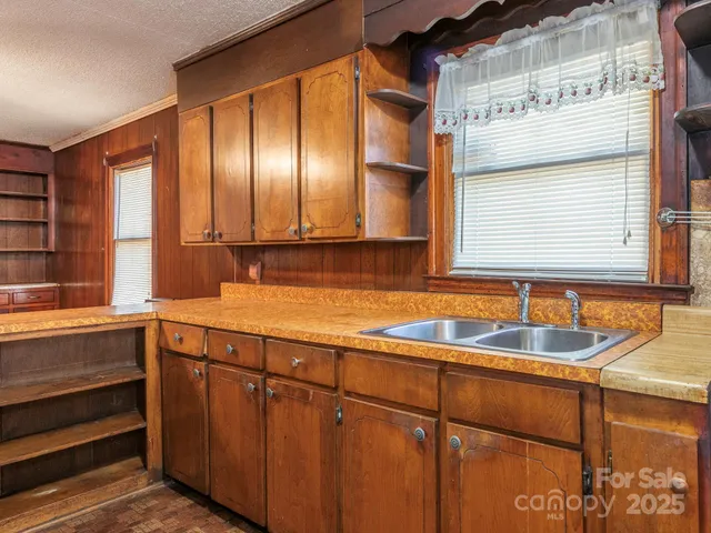 a kitchen with a sink and large window