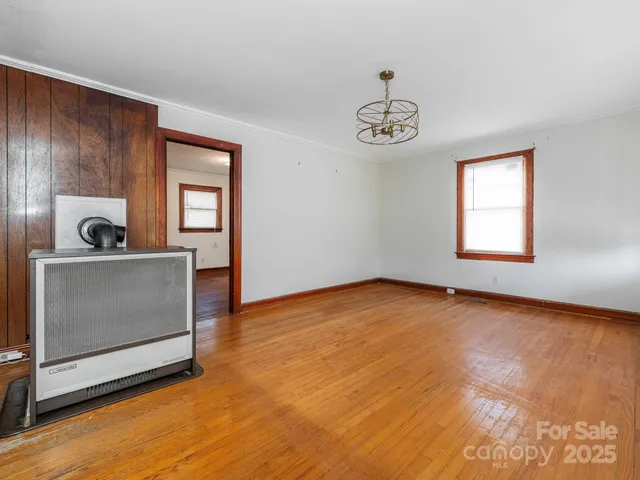 a view of a room with wooden floor cabinet and windows