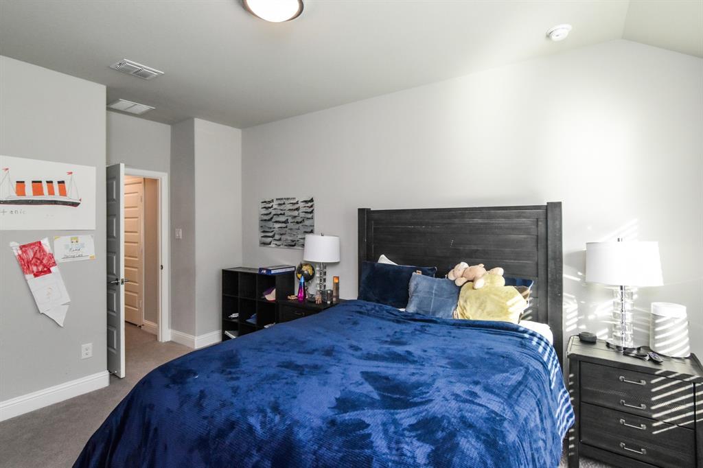 2516 Maidenhair Road Frisco, TX 75033 - Photo 26 of 30 a bedroom with a bed and a refrigerator