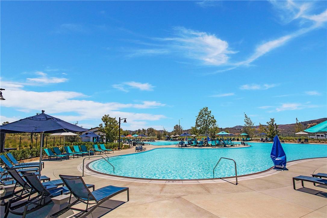 1401 Lasso Way, Unit 201 Rancho Mission Viejo, CA 92694 - Photo 31 of 69 a view of a swimming pool and lounge chairs