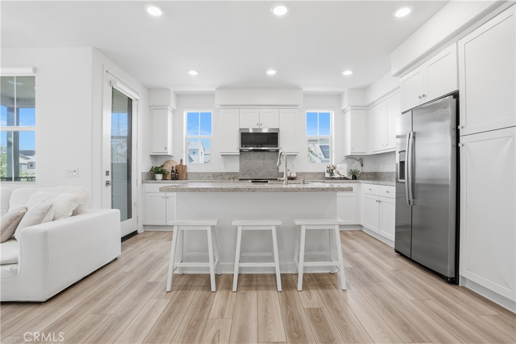 1401 Lasso Way, Unit 201 Rancho Mission Viejo, CA 92694 - Photo 6 of 69 a kitchen with stainless steel appliances a stove a sink refrigerator and a couch