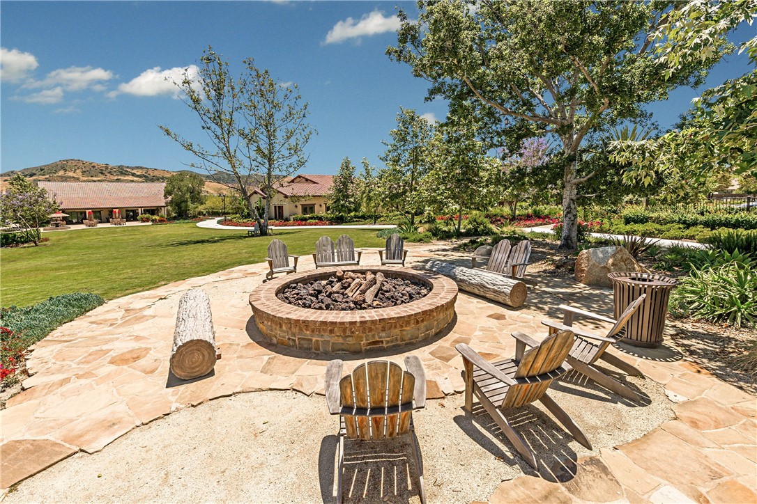 1401 Lasso Way, Unit 201 Rancho Mission Viejo, CA 92694 - Photo 63 of 69 a view of a swimming pool with a table and chairs