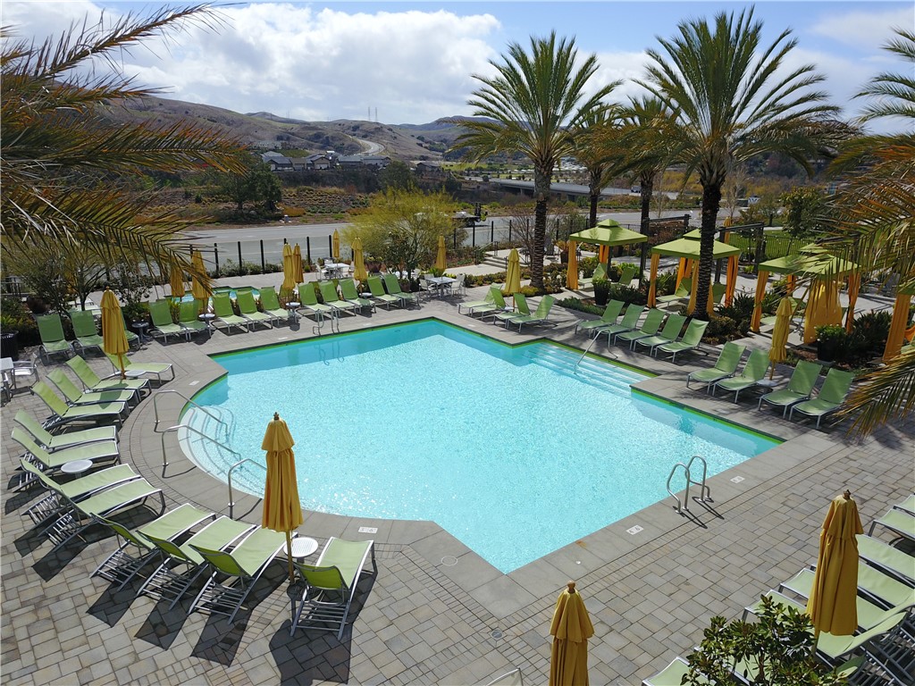 1401 Lasso Way, Unit 201 Rancho Mission Viejo, CA 92694 - Photo 66 of 69 a view of a swimming pool with a table and chairs