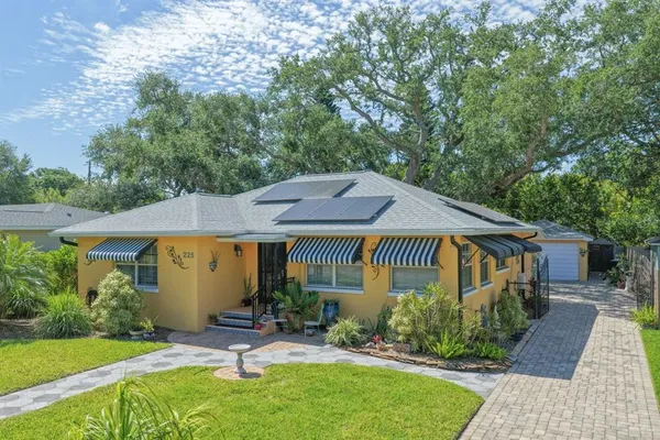 a view of a house with a yard patio and a garden