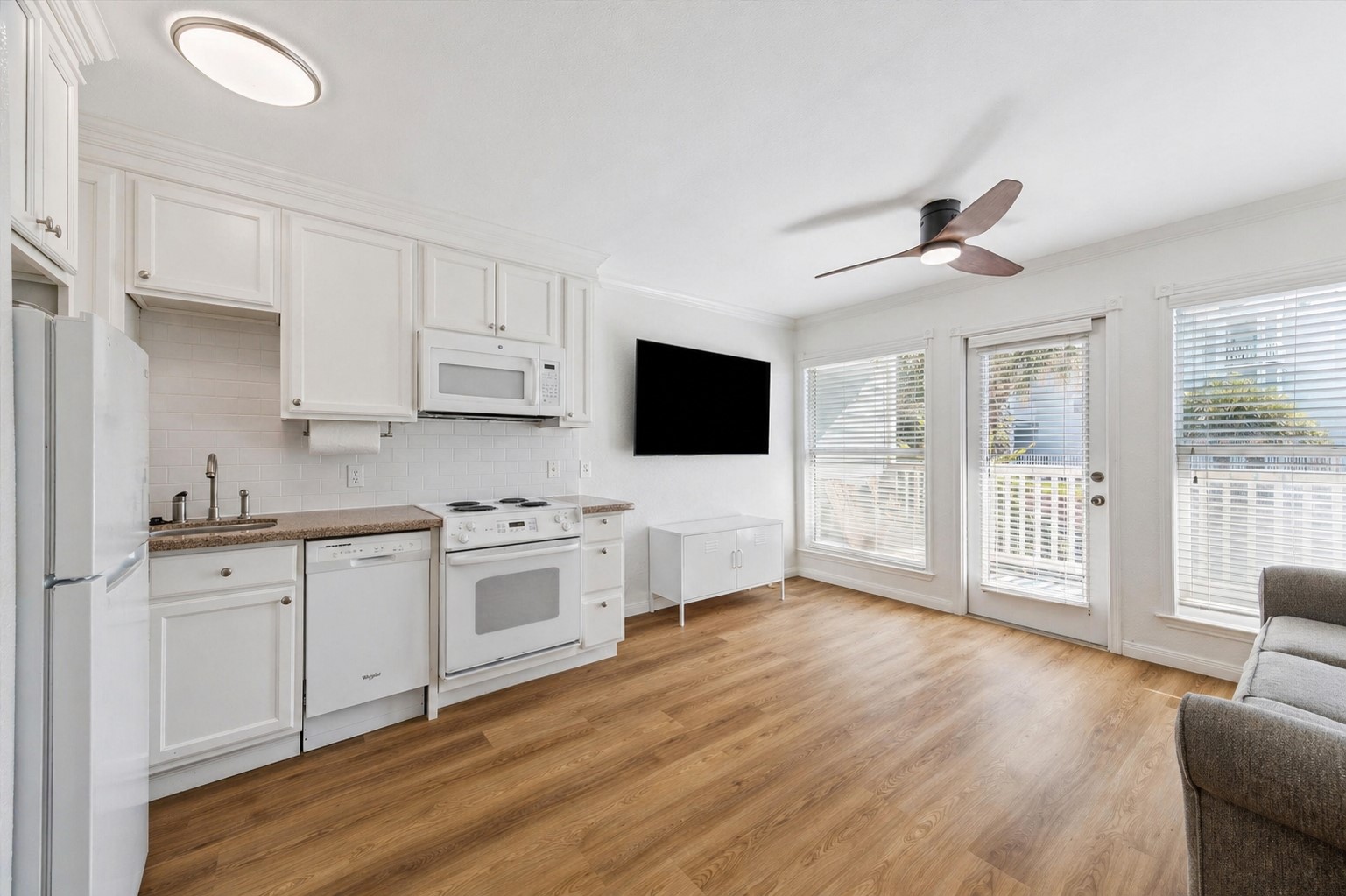 10811 Termini-San Luis Pass Road, Unit 1121 Galveston, TX 77554 - Photo 2 of 10 a large kitchen with cabinets wooden floor and stainless steel appliances
