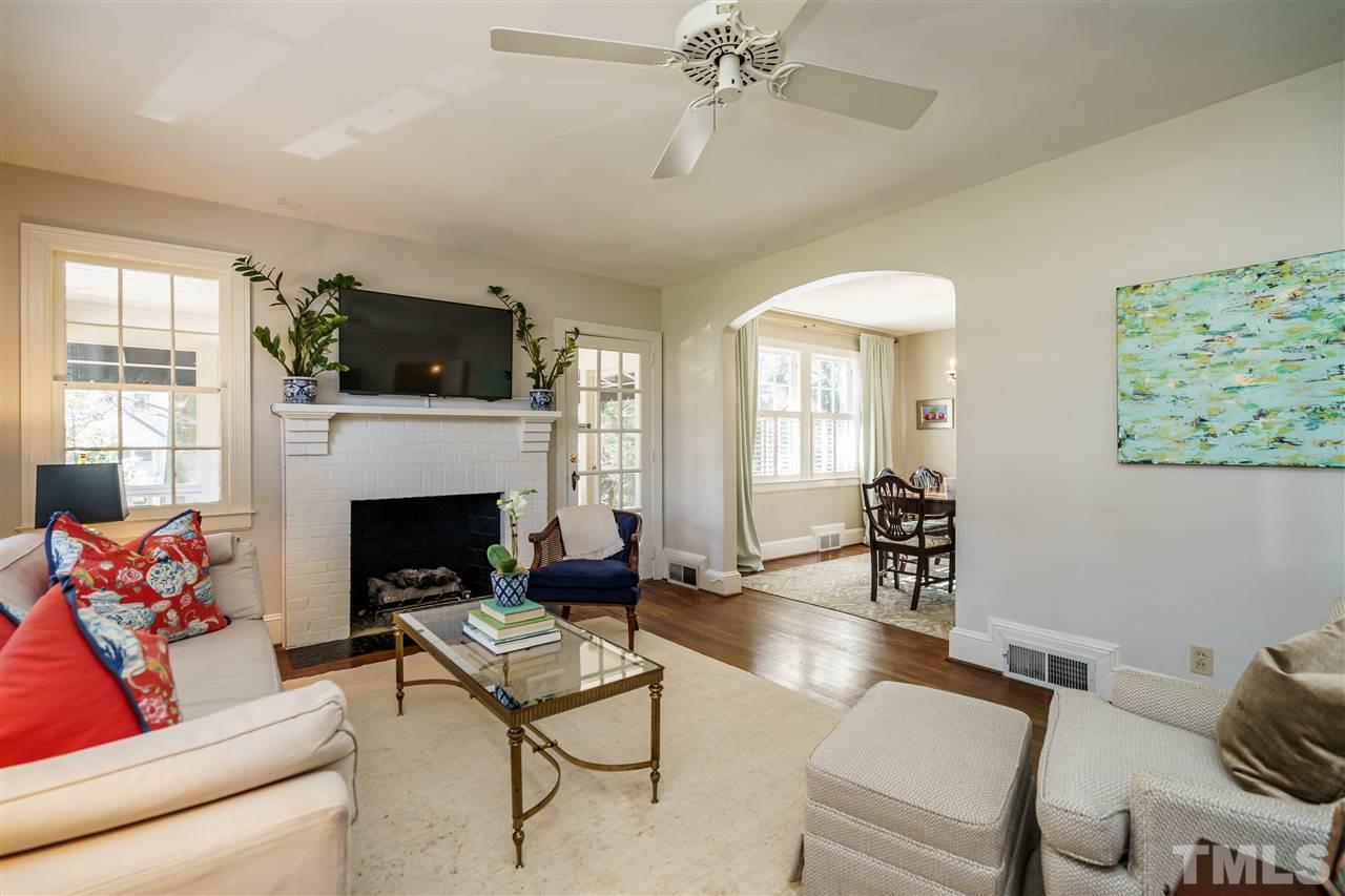 1301 Duplin Road Raleigh, NC 27607 - Photo 3 of 27 a living room with furniture a flat screen tv and a fireplace