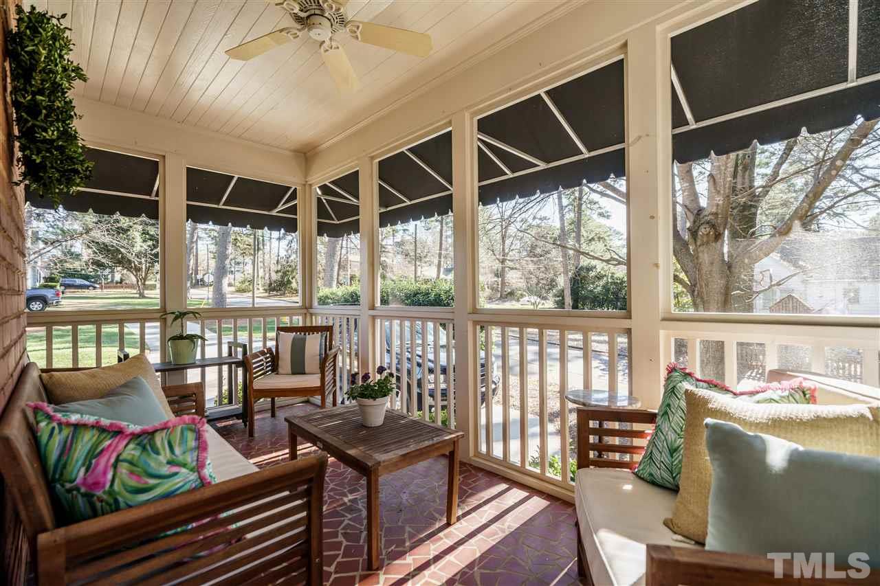 1301 Duplin Road Raleigh, NC 27607 - Photo 22 of 27 a living room with furniture and a floor to ceiling window
