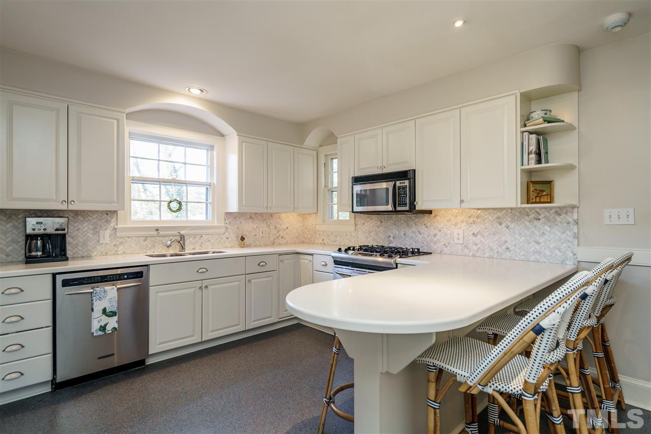 1301 Duplin Road Raleigh, NC 27607 - Photo 8 of 27 a kitchen with stainless steel appliances a sink table and chairs