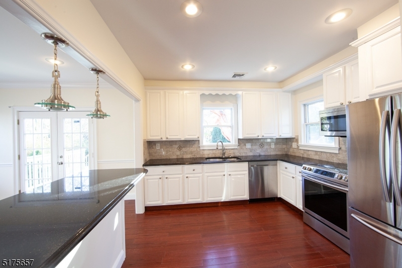 16 Columbus Avenue Glen Ridge, NJ 07028 - Photo 11 of 14 a kitchen with stainless steel appliances granite countertop a sink and stove