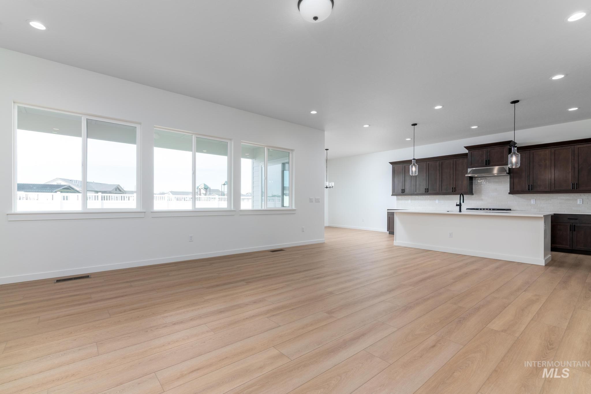 8459 South Country Wind Avenue Meridian, ID 83642 - Photo 4 of 11 Unfurnished living room with recessed lighting and light wood-style flooring