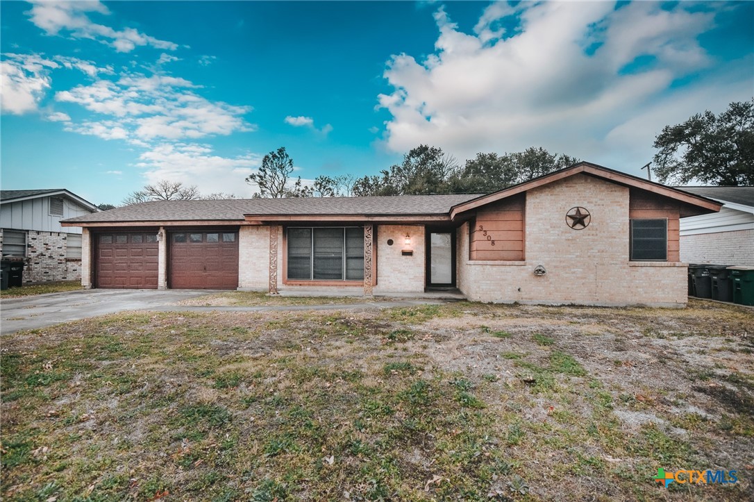 a view of a house with a yard and garage