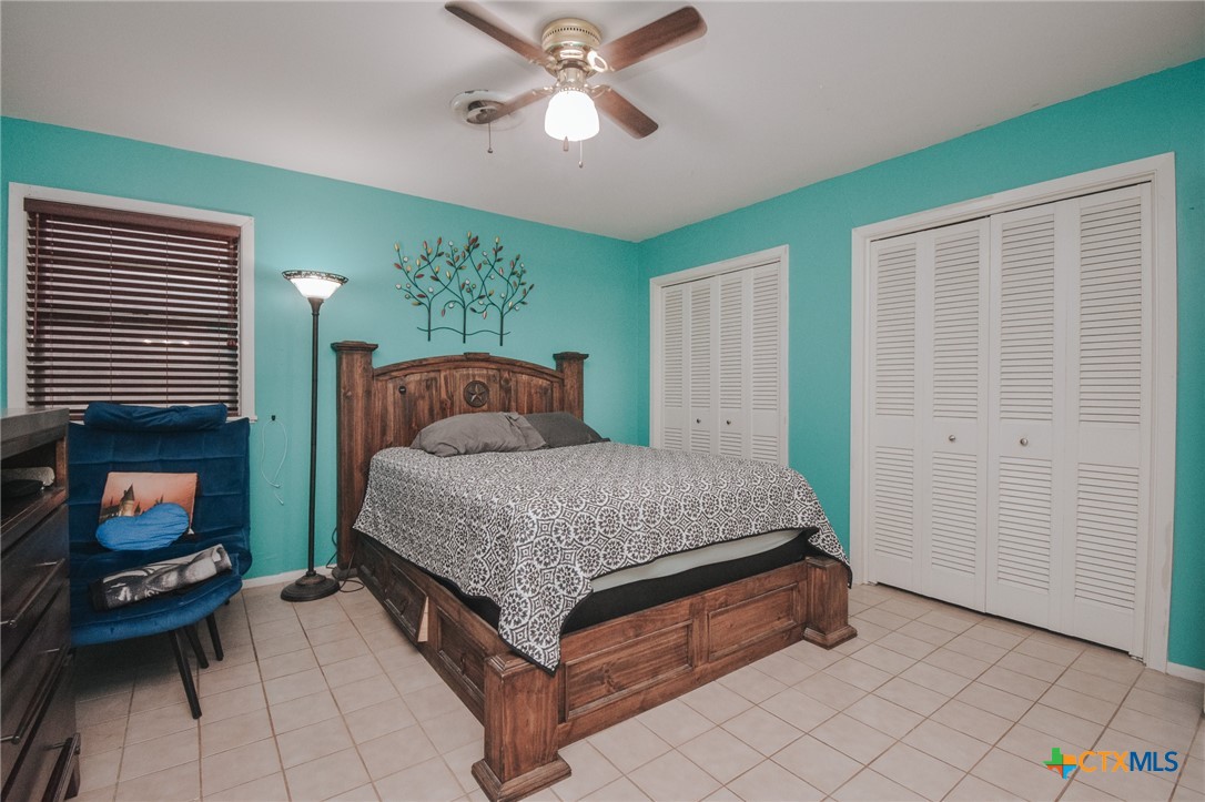 3308 Erwin Avenue Victoria, TX 77901 - Photo 11 of 16 a bedroom with a bed a window and a flat screen television