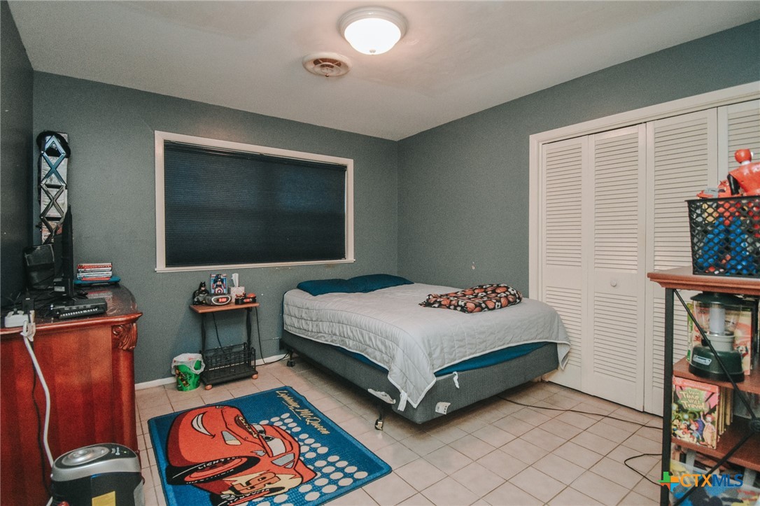 3308 Erwin Avenue Victoria, TX 77901 - Photo 13 of 16 a bedroom with a bed and a flat screen tv