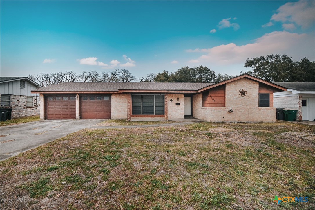 3308 Erwin Avenue Victoria, TX 77901 - Photo 2 of 16 a view of a house with a yard and garage