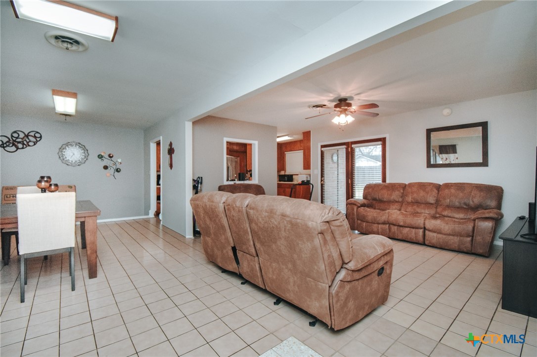 3308 Erwin Avenue Victoria, TX 77901 - Photo 4 of 16 a living room with furniture and a chandelier