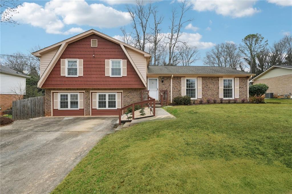 a front view of a house with yard and green space