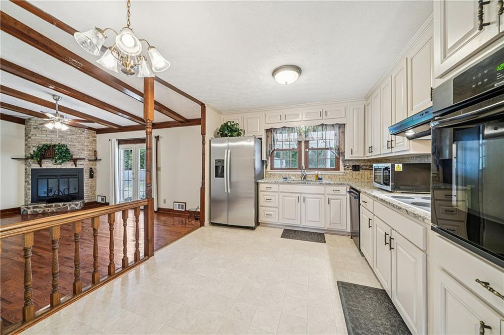 1315 Sanden Ferry Drive Decatur, GA 30033 - Photo 11 of 33 a kitchen with cabinets a sink and appliances