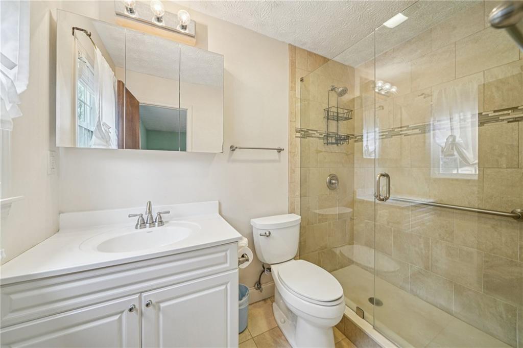 1315 Sanden Ferry Drive Decatur, GA 30033 - Photo 15 of 33 a bathroom with a sink toilet and shower