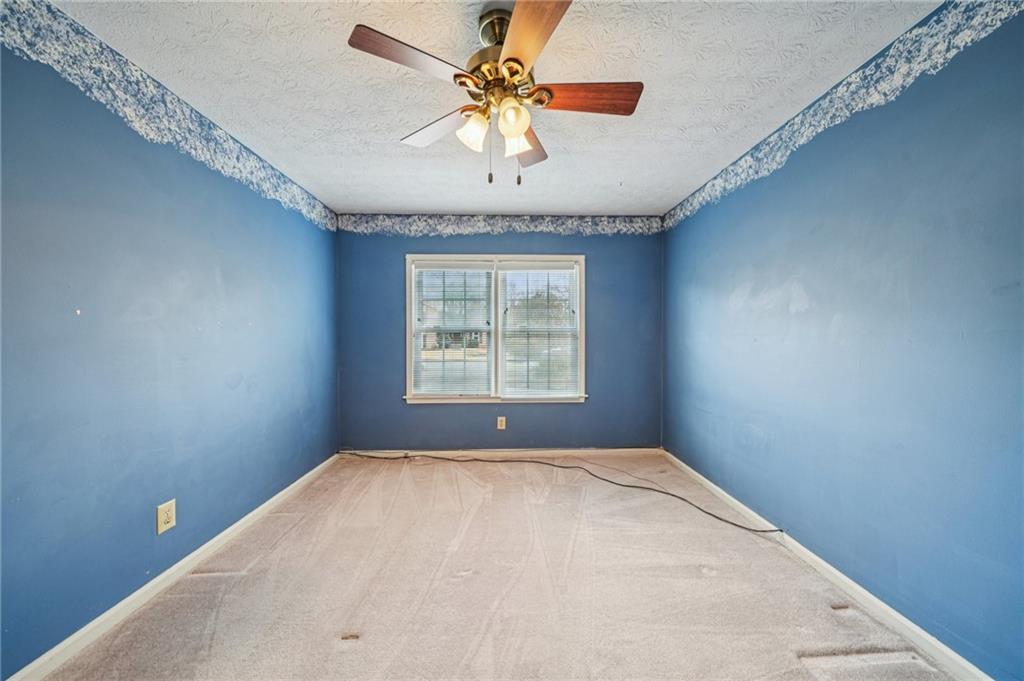 1315 Sanden Ferry Drive Decatur, GA 30033 - Photo 23 of 33 a view of a livingroom with a window and a ceiling fan