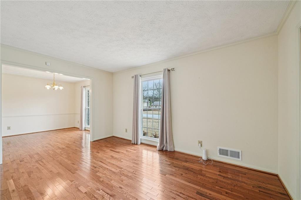 1315 Sanden Ferry Drive Decatur, GA 30033 - Photo 6 of 33 a view of an empty room with wooden floor and closet