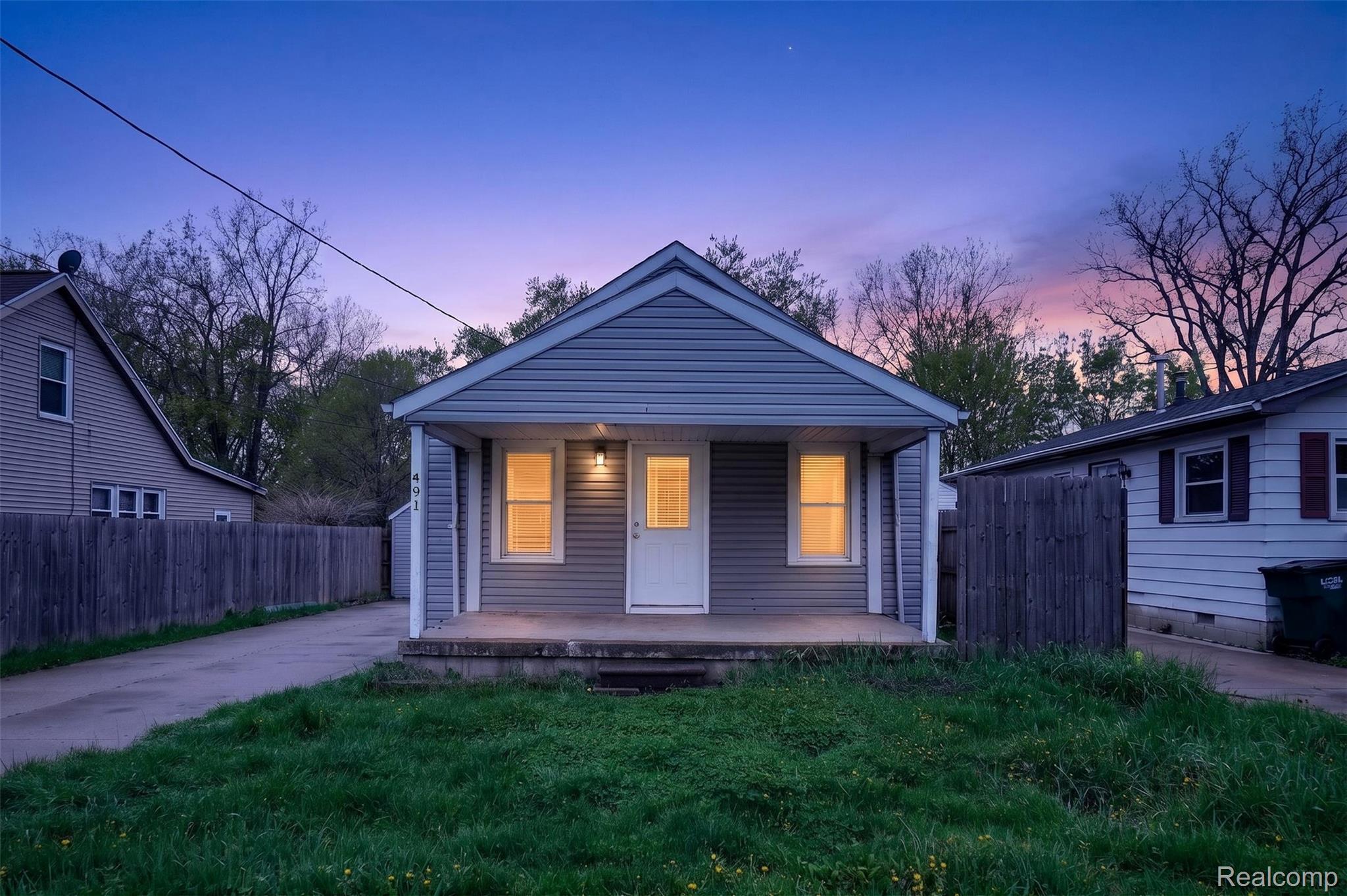 4910 Hughes Road Lansing, MI 48910 - Photo 1 of 27 View of front facade featuring a porch