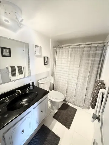 a kitchen with a sink a stove and chairs