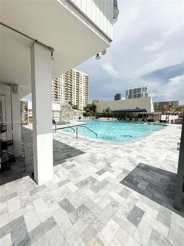 a front view of a house with a yard and potted plants